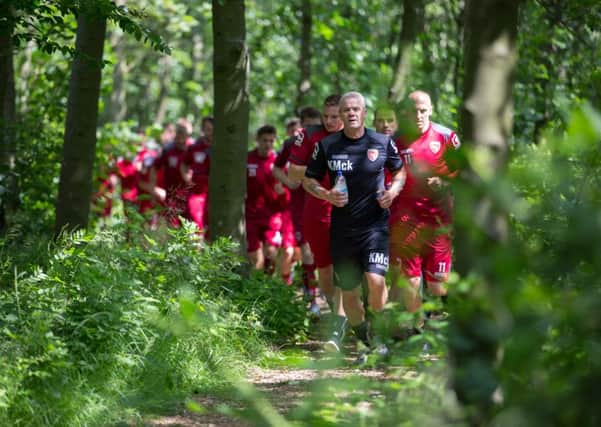 Ken McKenna leads Morecambe's players on a woodland run at Lancaster University. Picture: Matt Rushton