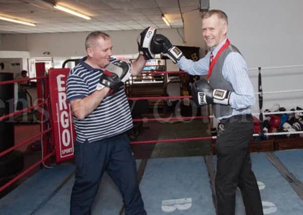 Mayor of Lancaster, Jon Barry, learns the art of boxing from coach Frank Harrington. Photo by Rachel Landsborough.
