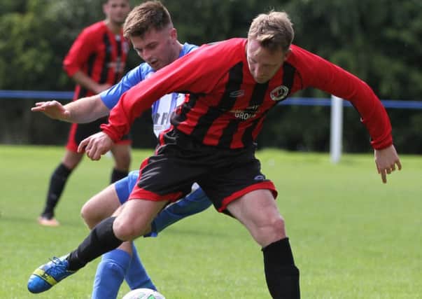 Slyne-with-Hest's Tom Entwistle battles with his Coppull namesake Tom Entwistle in the game between the two sides on Saturday.