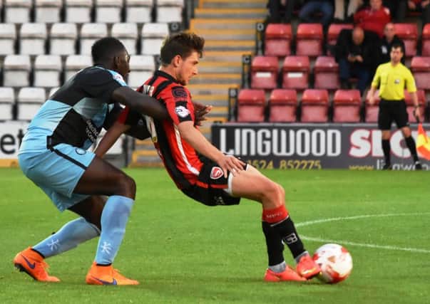 Shaun Miller battles for the ball against Wycombe.