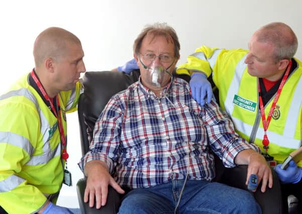 Picture by Julian Brown for LEP 24/08/15  Pictured left, Crew Manager Mark Cookson, John Taylor, acting as a patient and Firefighter Martin Sears take part in a drill  Launch of Community First Responder Scheme at Morecambe Fire Station  where Morecambe fire fighters will be trained to deal with medical 999 calls until ambulances arrive.