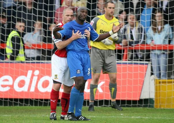 Jim Bentley battles with Sol Campbell during the famous game at Christie Park. Picture: PA Wire