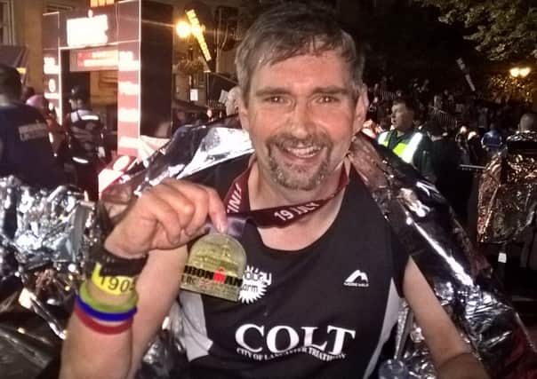Andy Forrest with his Iron Man medal.