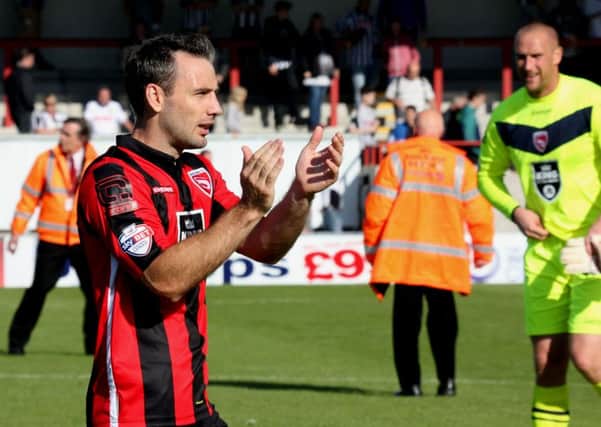 Alan Goodall salutes the Morecambe fans at the final whistle on Saturday.