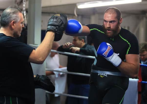 Heavyweight boxer Tyson Fury with trainer, and uncle, Peter Fury during a media work out at Peacock Gym, London. PRESS ASSOCIATION Photo. Nick Potts/PA Wire
