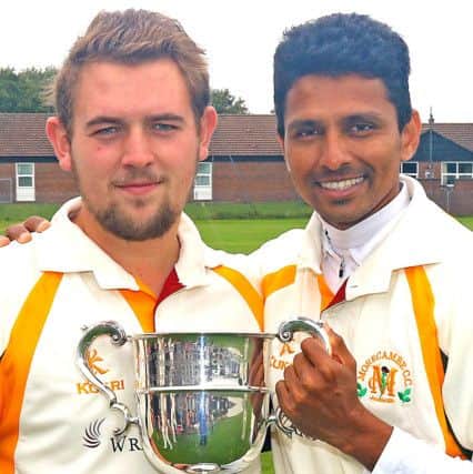 Star bowlers Eddy Read and Suraj Randiv celebrate with the Northern Premier League trophy. Picture: Tony North