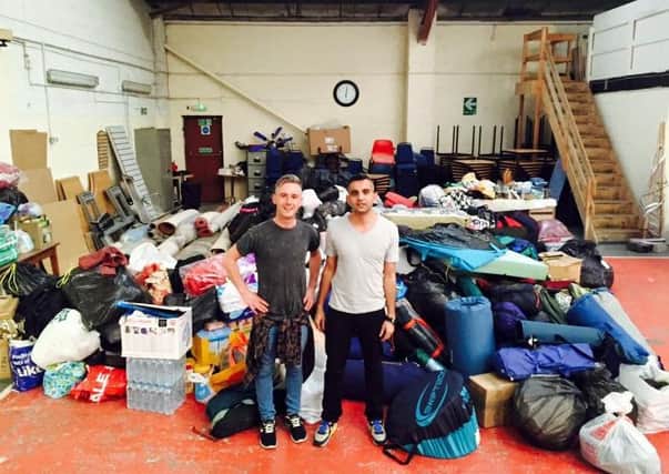 Robbie from Guys and Dolls with some of the group's donations at the drop-off point in Manchester.