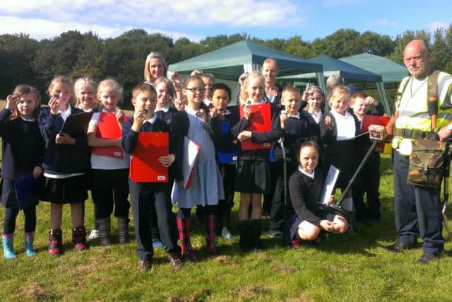 Year 5 pupils from Heysham Mossgate School with metal detectorist Terry Harvey at the dig site in Lancaster