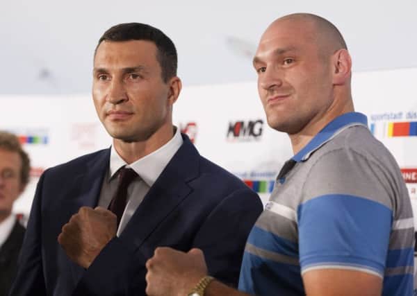Wladimir Klitschko and Tyson Fury pose during a news conference in Duesseldorf. Picture: AP/Bernd Lauter