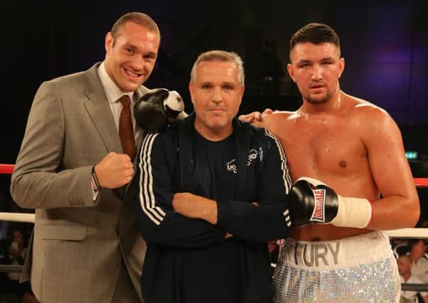 Peter Fury, centre, with Tyson, left, and son Hughie, right. Picture: Nick Potts/PA Wire