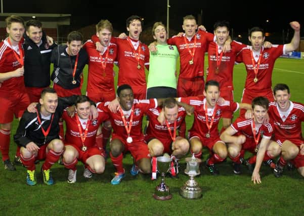Carnforth Rangers celebrate their Lancashire Cup triumph.
