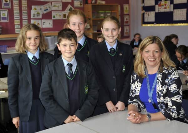 New Our Lady's Catholic College headteacher Helen Seddon with pupils, from left, Kathryn McCafferty, 13, Matthew Sheard, 12, Sophie Lee, 12, and Emily Kelsall, 12.