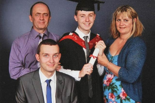 Michael pictured (front) with his parents Chris and Joanne at his brother David's graduation.