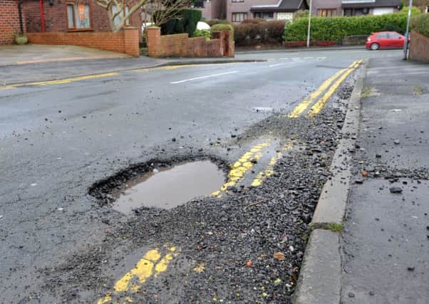 Large potholes causing danger to motorists and cyclists.