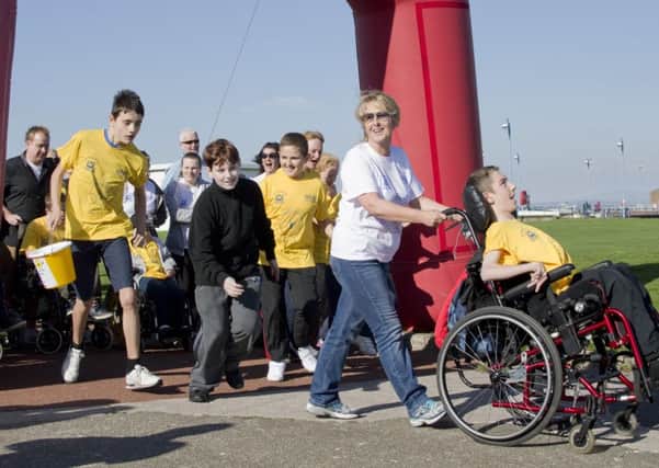 Highfurlong pupil Mateo Sanderson organised a fun walk in Morecambe, along with players from his favourite football team, to raise £5,000 for charity