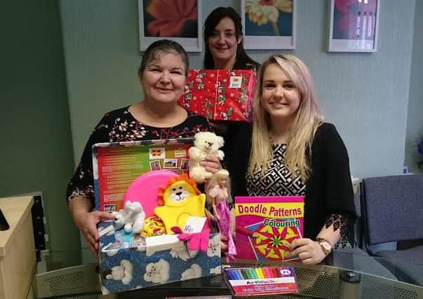 Jan Copestake, Jill Sanctuary and Becky Hulme from Baines Bagguley Penhale with some of the donated shoeboxes.