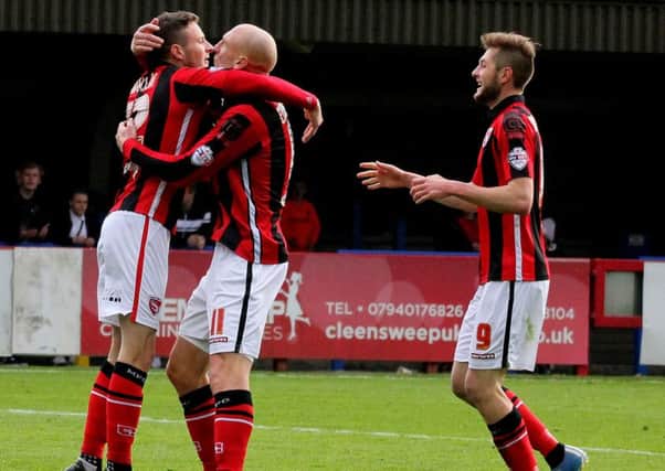 Morecambe celebrate their fifth goal at AFC Wimbledon, scored by Paul Mullin.