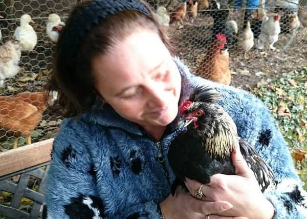 Tina Wlkinson with Captain Beaky and her other chickens.
