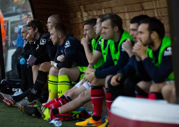 The Morecambe bench looks on at Plymouth.