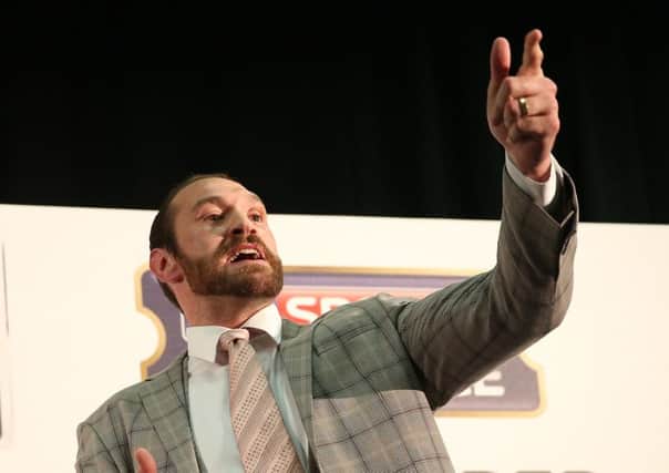 Tyson Fury gestures to the audience during a press conference at the Hilton Syon Park, London. PRESS ASSOCIATION Photo. Picture date: Wednesday September 23, 2015. See PA story BOXING Fury. Photo credit should read: Simon Cooper/PA Wire.