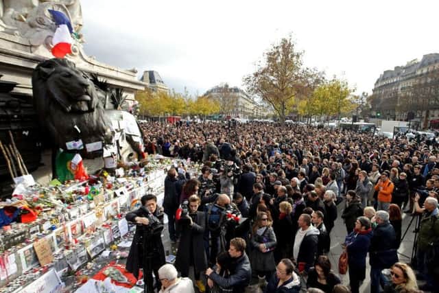 Crowds observce a minute's silence at the Place de la Republique, Paris