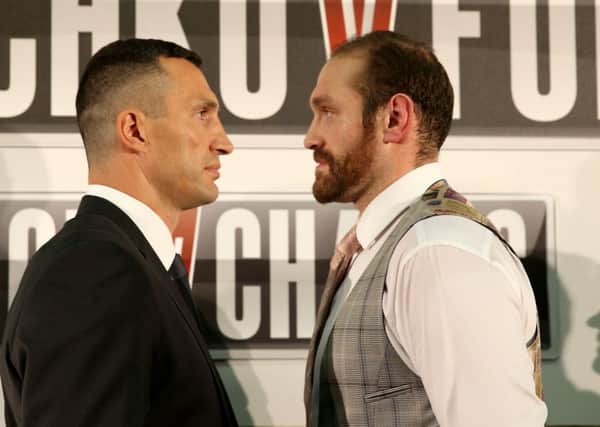 Wladimir Klitschko (left) and Tyson Fury stare down. Simon Cooper/PA Wire.