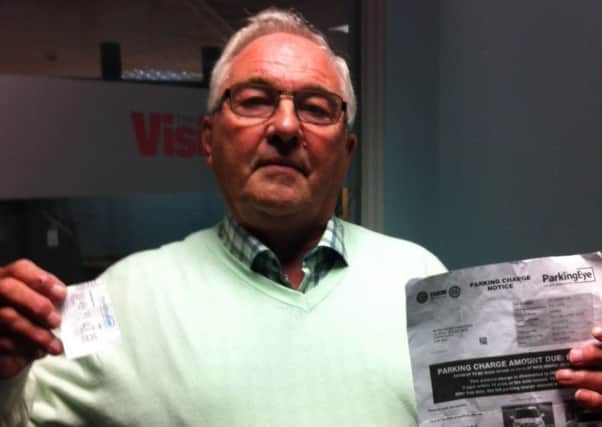 Ray Harrison with his parking ticket and the fine he received.
