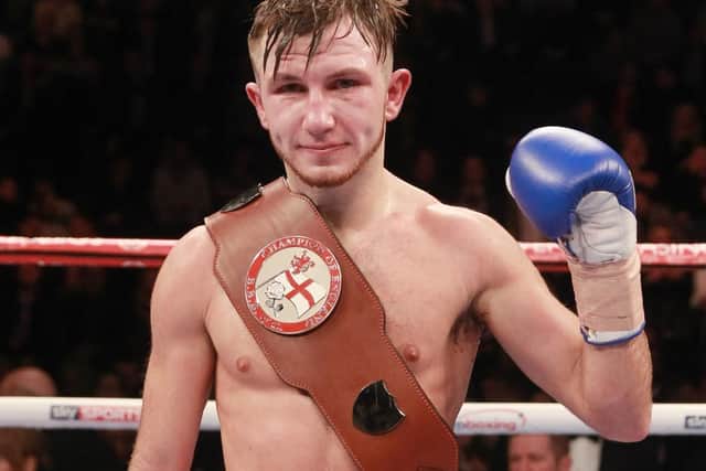 Isaac Lowe poses for the cameras after hanging onto his English featherweight title. Picture: Lawrence Lustig/Matchroom