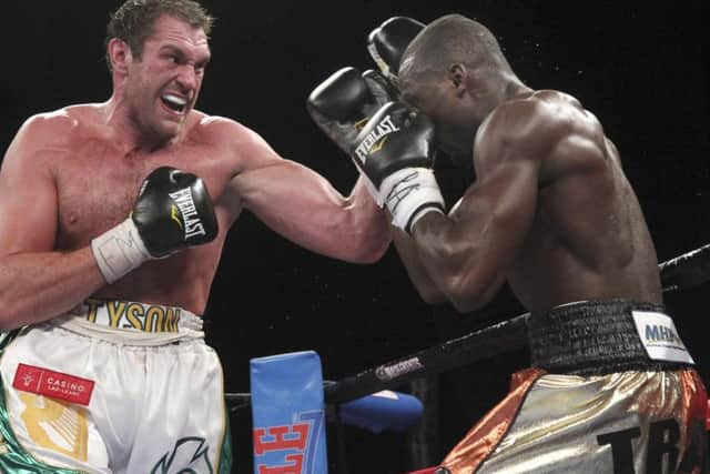 Tyson Fury, left, lands a punch on Steve Cunningham duirng a heavyweight boxing match, Saturday, April 20, 2013 at the Theatre at Madison Square Garden in New York. Fury knocked out Cunningham in the seventh round. (AP Photo/Mary Altaffer)