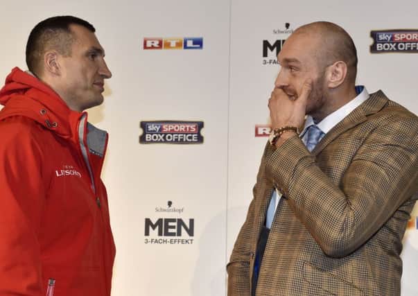 Challenger Tyson Fury, right,  and   world boxing champion Wladimir Klitschko, left,  attend  a press conference prior their heavyweight boxing fight in Duesseldorf, Germany, Tuesday, Nov. 24, 2015. The title  bout will take place in Duesseldorf's LTU arena on Saturday. (AP Photo/Martin Meissner)