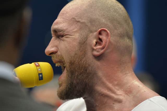 Tyson Fury sings after winning in a world heavyweight title fight for Ukraine's Wladimir Klitschko's WBA, IBF, WBO and  IBO belts in the Esprit Arena in Duesseldorf. (AP Photo/Martin Meissner)