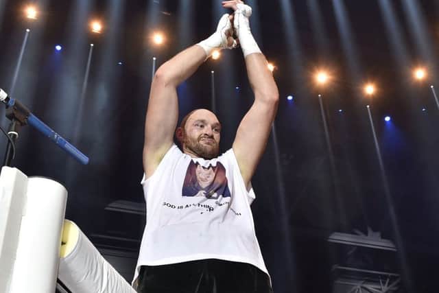 Tyson Fury celebrates after winning the world heavyweight title. Picture: AP Photo/Martin Meissner