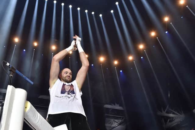 Fury celebrates his victory under the bright lights in Dusseldorf. Picture: AP Photo/Martin Meissner
