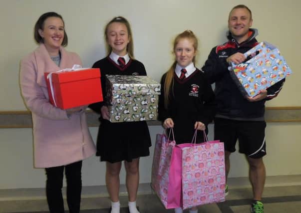 Morecambe High School Xmas presents donation. Pictured from left are : Olivia Shorrocks, Lily Cooper, Leona Rhodes and Leon Gievke with the presents.