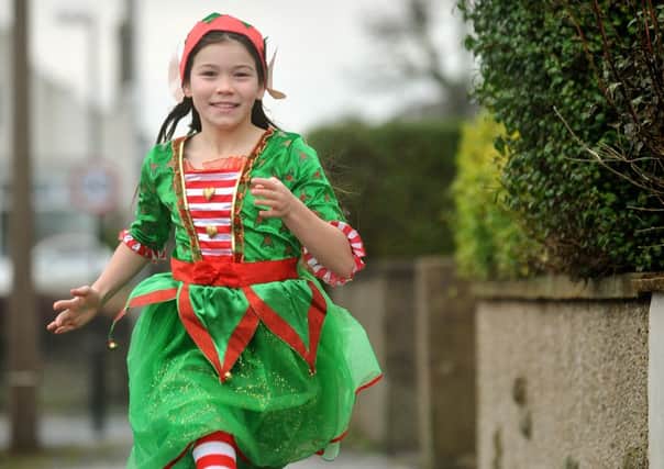 9 year-old Niamh Barnsley-Ryan, of Penrith Avenue in Heysham, will be beginning a year-long fundraising challenge at Christmas when she starts a run of over 800 miles (in stages!).
Christmas elf Niamh out for a practice run.  PIC BY ROB LOCK
14-12-2015