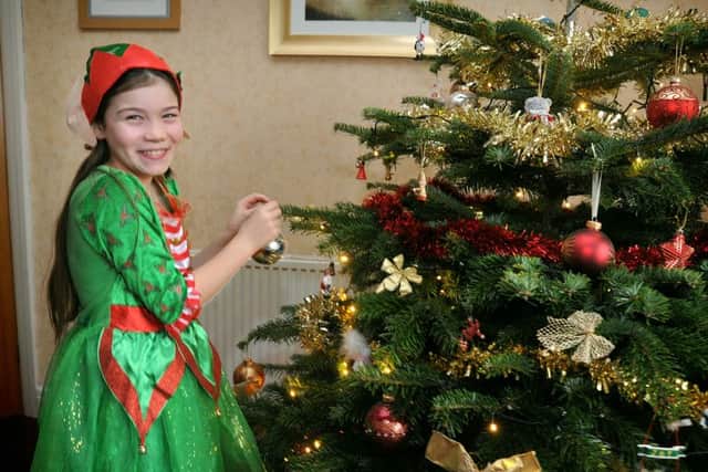 9 year-old Niamh Barnsley-Ryan, of Penrith Avenue in Heysham, will be beginning a year-long fundraising challenge at Christmas when she starts a run of over 800 miles (in stages!).
Christmas elf Niamh helps with Christmas tree decorating.  PIC BY ROB LOCK
14-12-2015