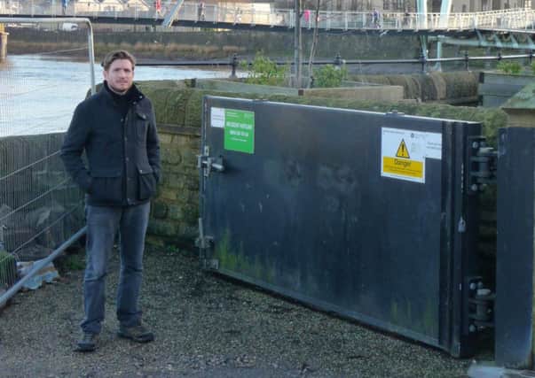 Coun Nick Wilkinson next to the flood gates at St George's Quay