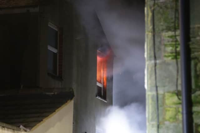 Flames can be seen glowing in a window at the scene of a fire on Albert Road in Morecambe.Pic: David Hodgson.
