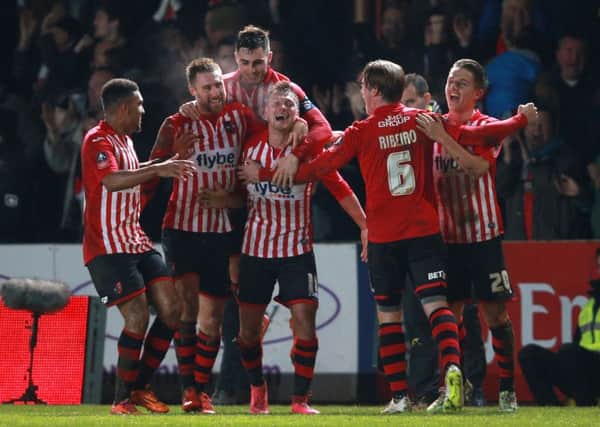 Exeter City's Lee Holmes celebrates after scoring his side's second goal against Liverpool. Picture: David Davies/PA Wire.