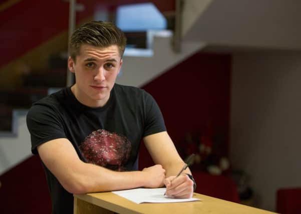 Aaron McGowan signs his new two-year contract with Morecambe.