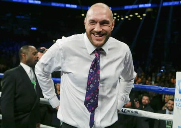 Tyson Fury smiles after Deontay Wilder's win. Picture: AP Photo/Frank Franklin II