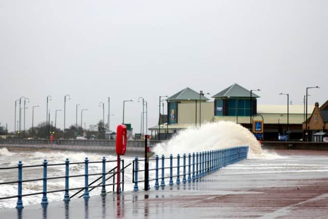 Waves crash over the railings onto the promenade at Morecambe near The Midland hotel. Pic: Chris Foote.