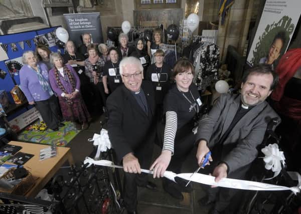The Children's Society have opened a 'pop-up' shop at Lancaster Priory Church.  Pictured are the Rev Chris Newlands, shop manager Faye Smyth and The Ven Michael Everitt, Archdeacon of Lancaster with volunteers behind.