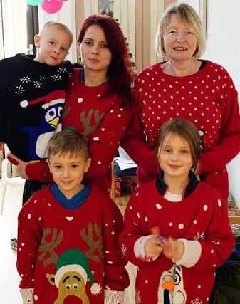 Ian's wife Aleksandra, mum Jean and children Tia, seven, Cameron, six, and four-year-old Oskar. They are dressed in Christmas jumpers donated to the hospice by the Ahmadiyya Muslim Youth Association North West.