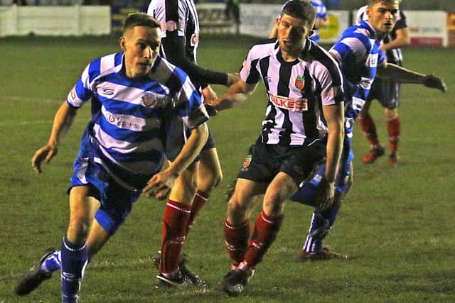 Billy Akrigg looks for an opening, watched by former Dolly Blues defender Adam Freeland. Picture: Tony North