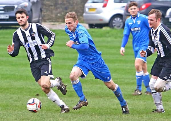 Joe Bouskill looks for an opening for Caton United.
 Picture: Tony North