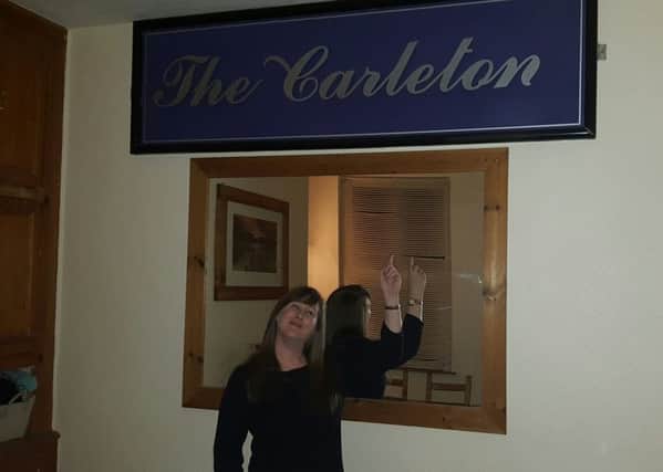 Sarah Sullivan with the Carleton sign now taking pride of place in her dining room.
