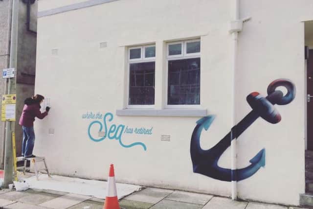 Artist Kate 'Sundae' Drummond at work on the Victoria Street Press graffiti project.