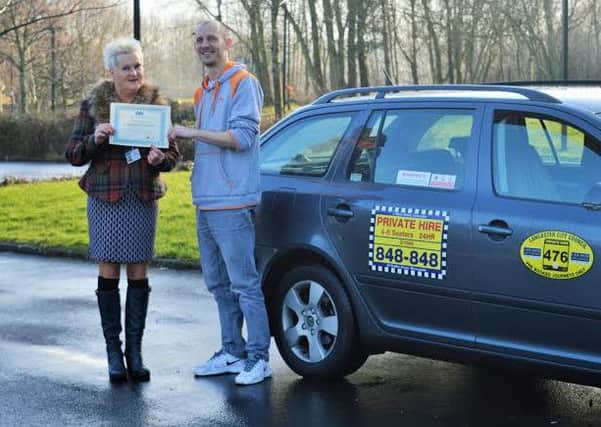 Taxi driver Simon Ball from Lancaster receives his certificate for completing the CSE training from Coun Margaret Pattison.