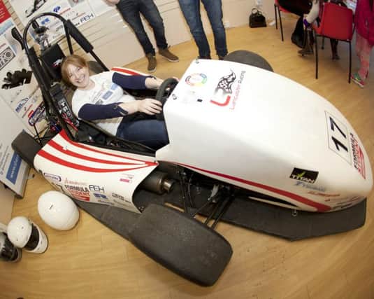 Campus in the Citys co-manager Lindsey King tries out Lancaster Universitys student-built racing car